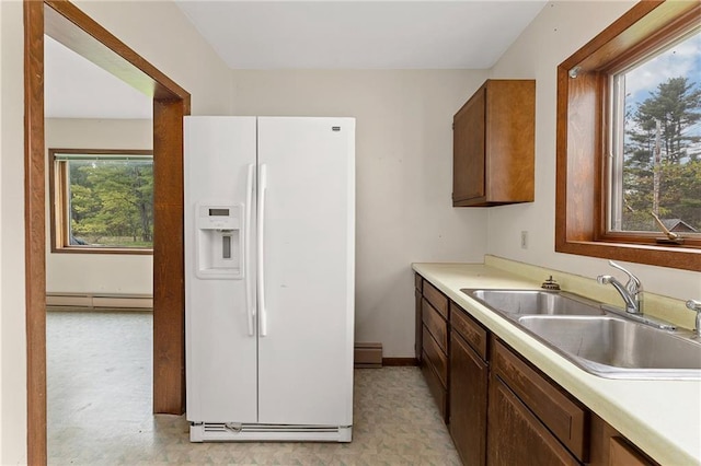 N7681 Jagielo Rd, Pittsville, WI 54466 - kitchen featuring white refrigerator with ice dispenser, a baseboard radiator, a sink, and light countertops