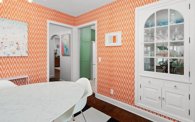4106 Meyer Ave, Madison, WI 53711 - dining room featuring wallpapered walls, baseboards, dark wood-style floors, and arched walkways