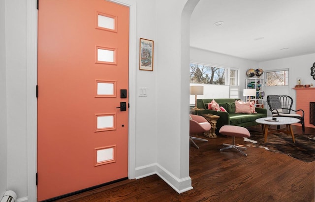 4106 Meyer Ave, Madison, WI 53711 - foyer entrance featuring dark wood-style floors, a baseboard radiator, arched walkways, baseboards, and a fireplace
