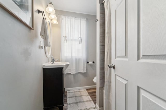 1578 Cass St, Green Bay, WI 54302 - full bathroom featuring wood finished floors, vanity, toilet, and baseboards