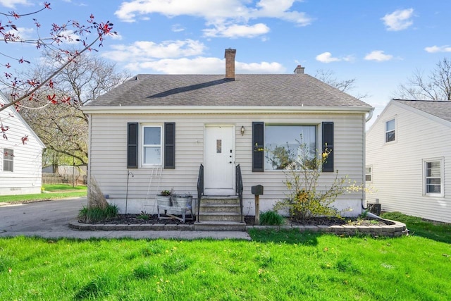1578 Cass St, Green Bay, WI 54302 - view of front facade featuring a chimney, a front lawn, and entry steps