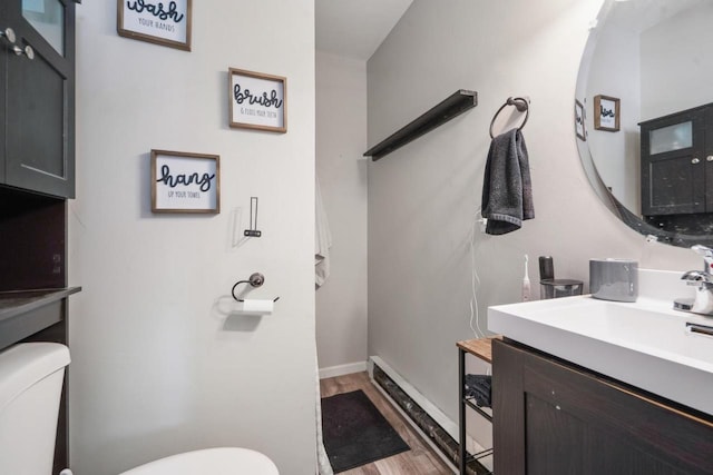 1578 Cass St, Green Bay, WI 54302 - bathroom with toilet, wood finished floors, vanity, and baseboards