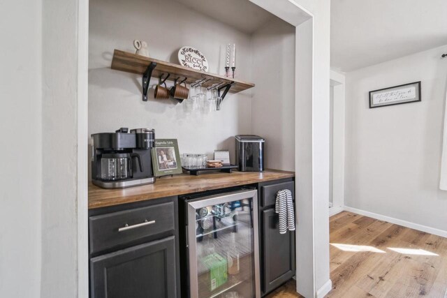 1578 Cass St, Green Bay, WI 54302 - indoor dry bar featuring wine cooler, light wood finished floors, and baseboards