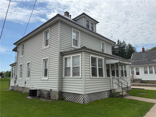 23923 Washington St, Independence, WI 54747 - view of home's exterior with entry steps, a yard, and central air condition unit