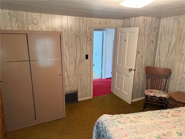 23923 Washington St, Independence, WI 54747 - carpeted bedroom featuring wood walls and baseboards