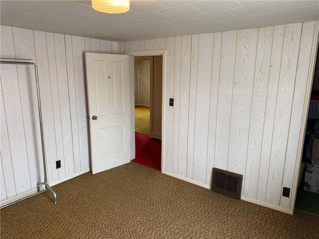 23923 Washington St, Independence, WI 54747 - unfurnished bedroom with carpet flooring, wood walls, and baseboards