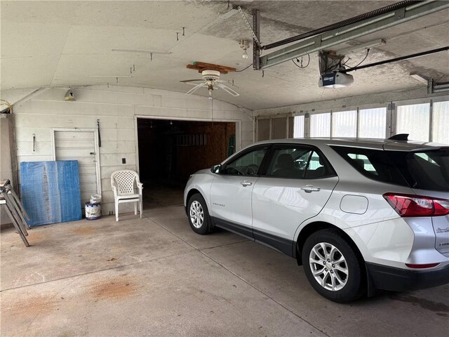 23923 Washington St, Independence, WI 54747 - garage featuring a garage door opener and concrete block wall