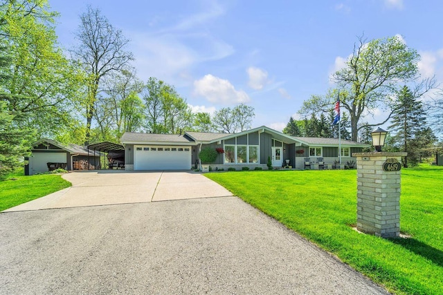 4619 Stonebridge Dr, Racine, WI 53404 - mid-century home featuring a front yard, driveway, an attached garage, and board and batten siding