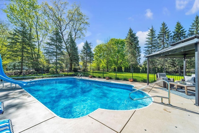 4619 Stonebridge Dr, Racine, WI 53404 - view of swimming pool with a water slide, a patio area, and view of scattered trees