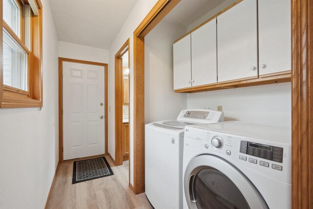 119 White St, Benton, WI 53803 - laundry area with cabinet space, light wood-style floors, and washer and dryer