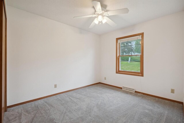 119 White St, Benton, WI 53803 - empty room featuring carpet flooring, baseboards, and ceiling fan