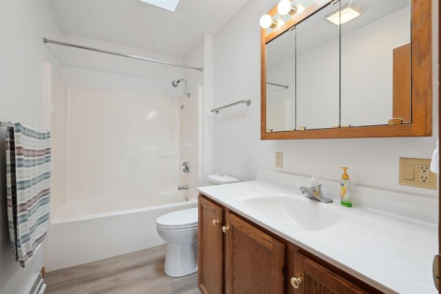 119 White St, Benton, WI 53803 - bathroom with wood finished floors, toilet, vanity, shower / washtub combination, and a skylight