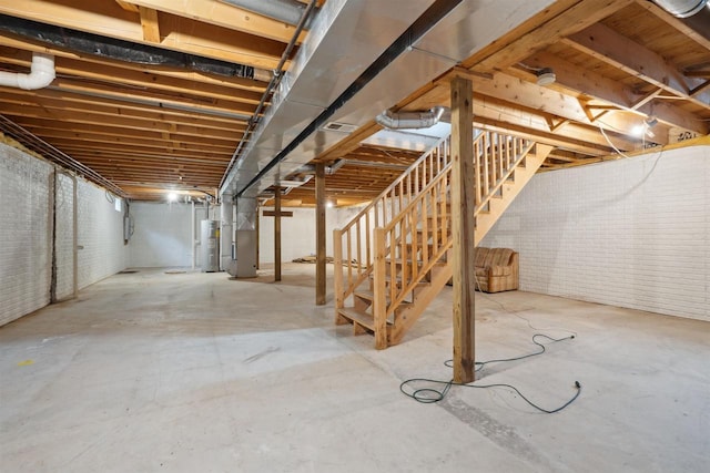 119 White St, Benton, WI 53803 - unfinished below grade area featuring water heater, stairs, heating unit, and brick wall