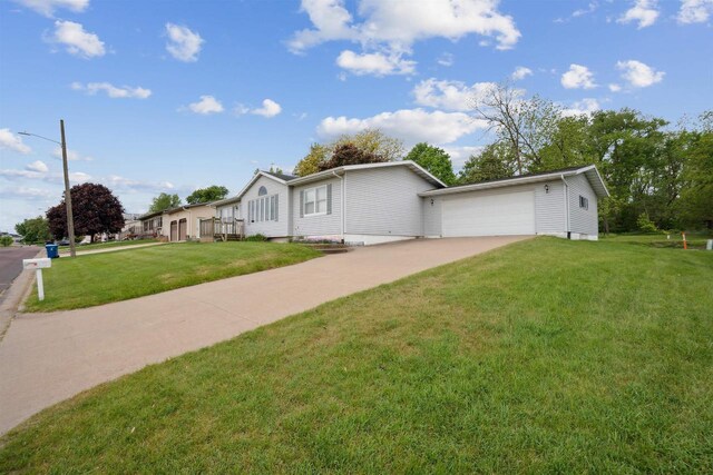 119 White St, Benton, WI 53803 - view of home's exterior with driveway, a yard, and an attached garage