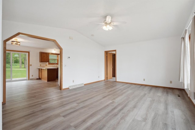 119 White St, Benton, WI 53803 - unfurnished living room with a ceiling fan, vaulted ceiling, light wood finished floors, and baseboards