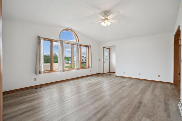 119 White St, Benton, WI 53803 - unfurnished living room with a ceiling fan, vaulted ceiling, plenty of natural light, light wood-style flooring, and baseboards