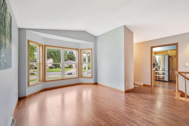 716 Grace St, Verona, WI 53593 - spare room with light wood finished floors, baseboards, and vaulted ceiling
