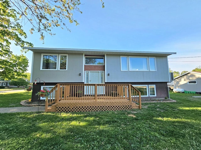 314 Jefferson St, Houston, MN 55943 - rear view of house with a lawn, brick siding, and a deck