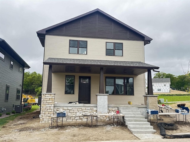 452 Gunderson Dr, Portage, WI 53901 - view of front of home featuring a porch, cooling unit, and stone siding