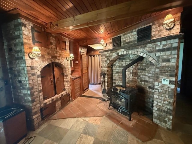 228227 County Road Y, Birnamwood, WI 54414 - wine room featuring a wood stove, wooden ceiling with exposed beams, and brick wall