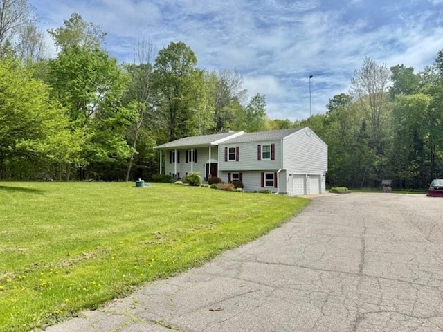 228227 County Road Y, Birnamwood, WI 54414 - split foyer home with a garage, asphalt driveway, and a front lawn