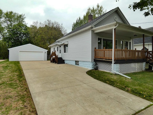 522 Goodell St, Green Bay, WI 54301 - view of front facade with a chimney, an outbuilding, a garage, and a porch