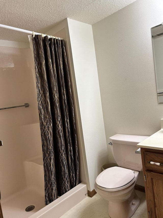 1010 Whispering Winds Pl, Onalaska, WI 54650 - bathroom with a stall shower, a textured ceiling, baseboards, vanity, and toilet