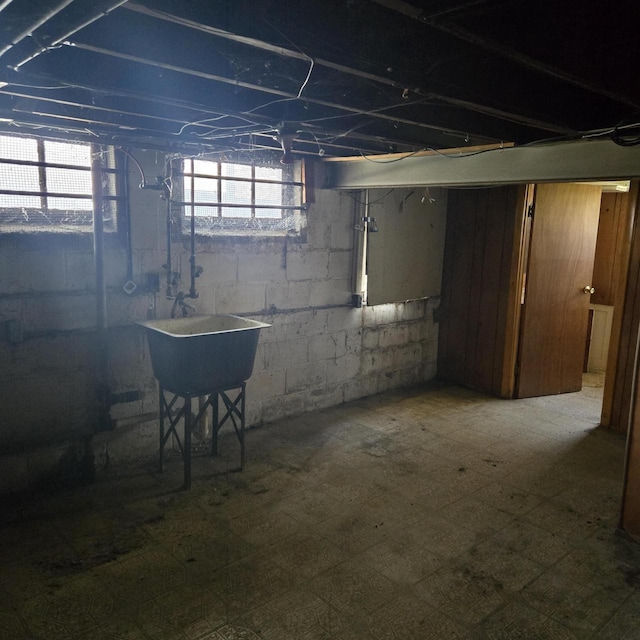 below grade area featuring tile patterned floors and a sink