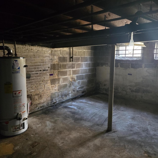 below grade area with water heater and concrete block wall