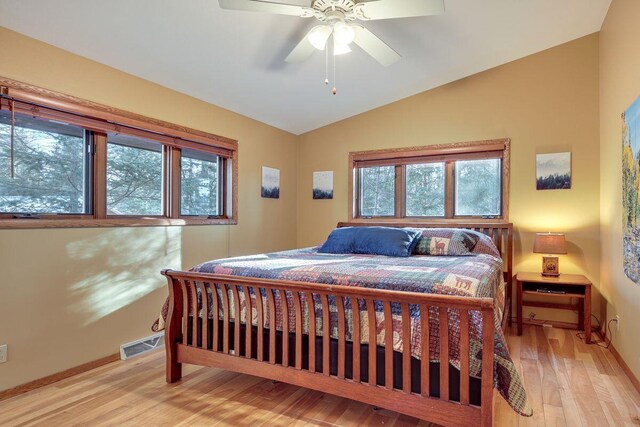1948 Wild Life Ln, Eagle River, WI 54521 - bedroom featuring vaulted ceiling, multiple windows, light wood finished floors, and baseboards