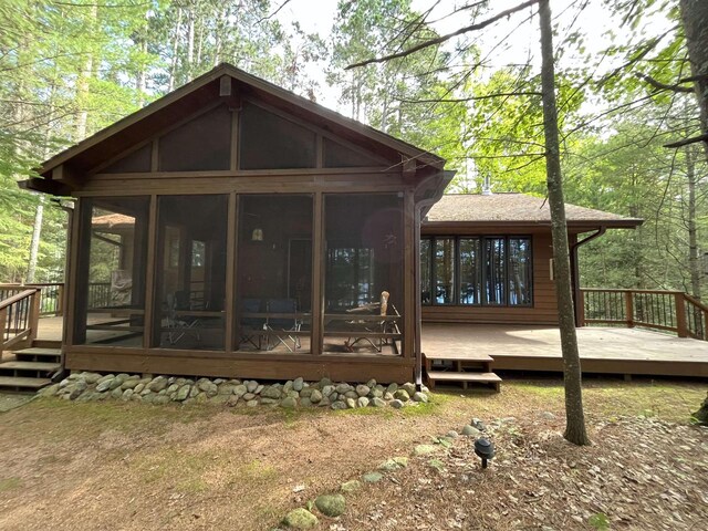 1948 Wild Life Ln, Eagle River, WI 54521 - back of house featuring a sunroom and a deck