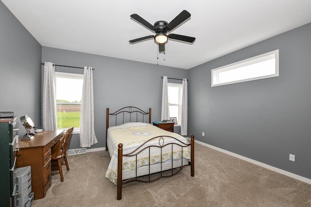 5150 Fairmont Dr, Milton, WI 53563 - carpeted bedroom featuring a desk, baseboards, and a ceiling fan