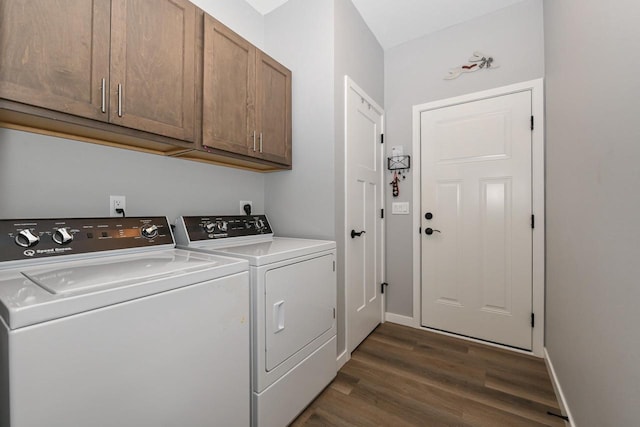 5150 Fairmont Dr, Milton, WI 53563 - laundry area featuring washing machine and clothes dryer, cabinet space, dark wood-style flooring, and baseboards
