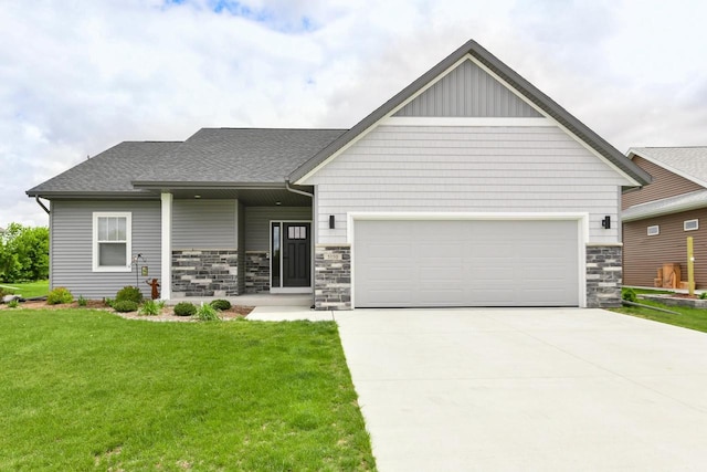 5150 Fairmont Dr, Milton, WI 53563 - view of front of house with a garage, a front lawn, concrete driveway, stone siding, and roof with shingles