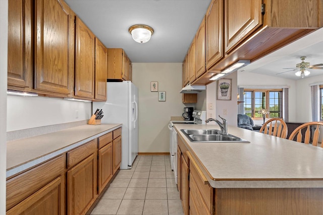 267 Oconomowoc Pkwy, Oconomowoc, WI 53066 - kitchen with a sink, white appliances, light countertops, and light tile patterned flooring