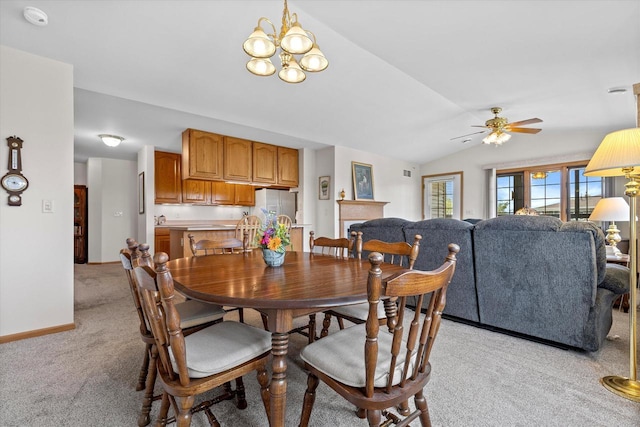 267 Oconomowoc Pkwy, Oconomowoc, WI 53066 - dining room with light carpet, vaulted ceiling, ceiling fan, a chandelier, and baseboards