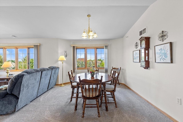 267 Oconomowoc Pkwy, Oconomowoc, WI 53066 - carpeted dining space featuring a chandelier, healthy amount of natural light, and baseboards