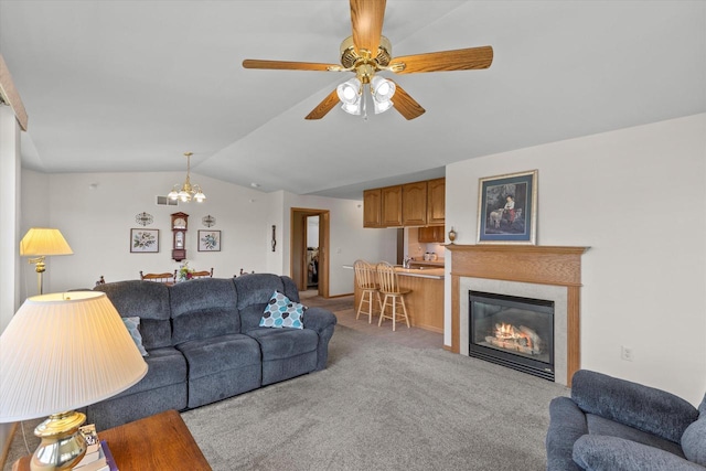 267 Oconomowoc Pkwy, Oconomowoc, WI 53066 - living room featuring vaulted ceiling, light colored carpet, ceiling fan, a glass covered fireplace, and a chandelier