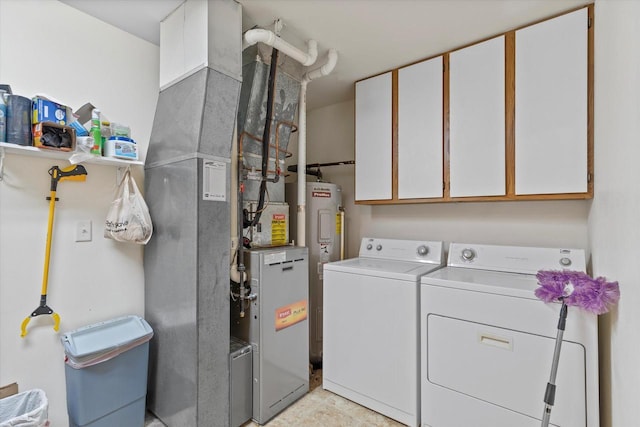 267 Oconomowoc Pkwy, Oconomowoc, WI 53066 - laundry room featuring washer and dryer, cabinet space, electric water heater, and heating unit