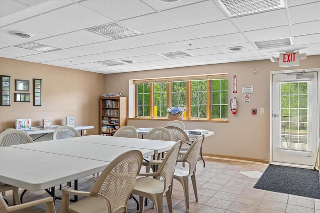 267 Oconomowoc Pkwy, Oconomowoc, WI 53066 - dining space with a drop ceiling, baseboards, and light tile patterned floors