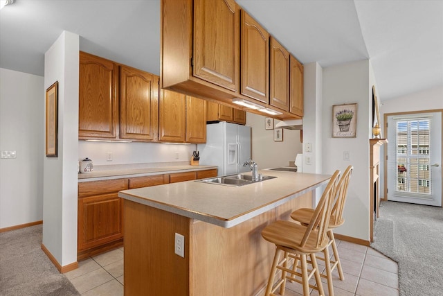267 Oconomowoc Pkwy, Oconomowoc, WI 53066 - kitchen featuring white refrigerator with ice dispenser, a sink, light tile patterned flooring, and light countertops
