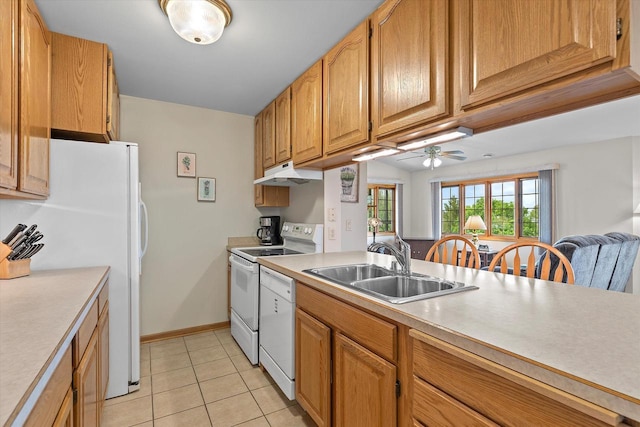 267 Oconomowoc Pkwy, Oconomowoc, WI 53066 - kitchen with a sink, white appliances, under cabinet range hood, light countertops, and light tile patterned flooring