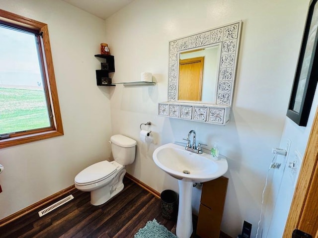 N5893 Walnut Rd, Monticello, WI 53570 - half bathroom with toilet, wood finished floors, baseboards, and a sink
