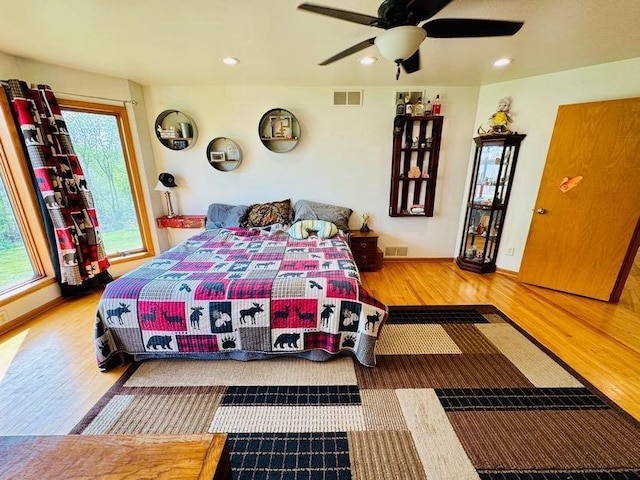 N5893 Walnut Rd, Monticello, WI 53570 - bedroom with wood finished floors, multiple windows, baseboards, recessed lighting, and ceiling fan