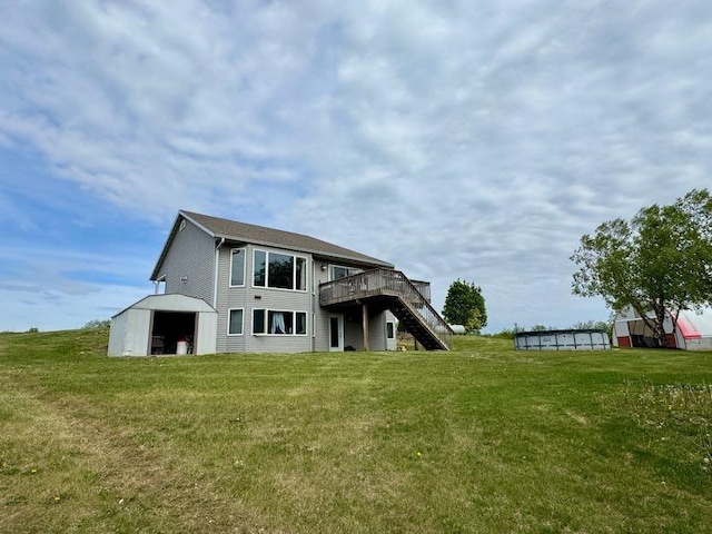 N5893 Walnut Rd, Monticello, WI 53570 - back of house with a lawn, a deck, and an outbuilding