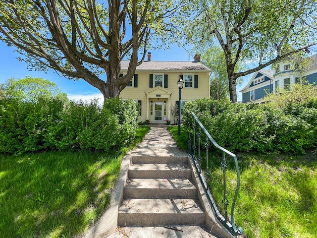 colonial-style house with a chimney