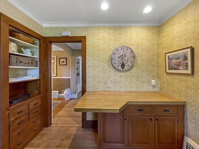 office area featuring crown molding, arched walkways, wallpapered walls, and light wood-type flooring