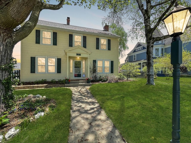 colonial-style house featuring a chimney