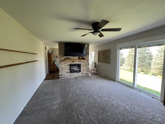 7401 Mildred Ct, Cross Plains, WI 53528 - unfurnished living room with carpet floors, ceiling fan, a fireplace, and baseboards