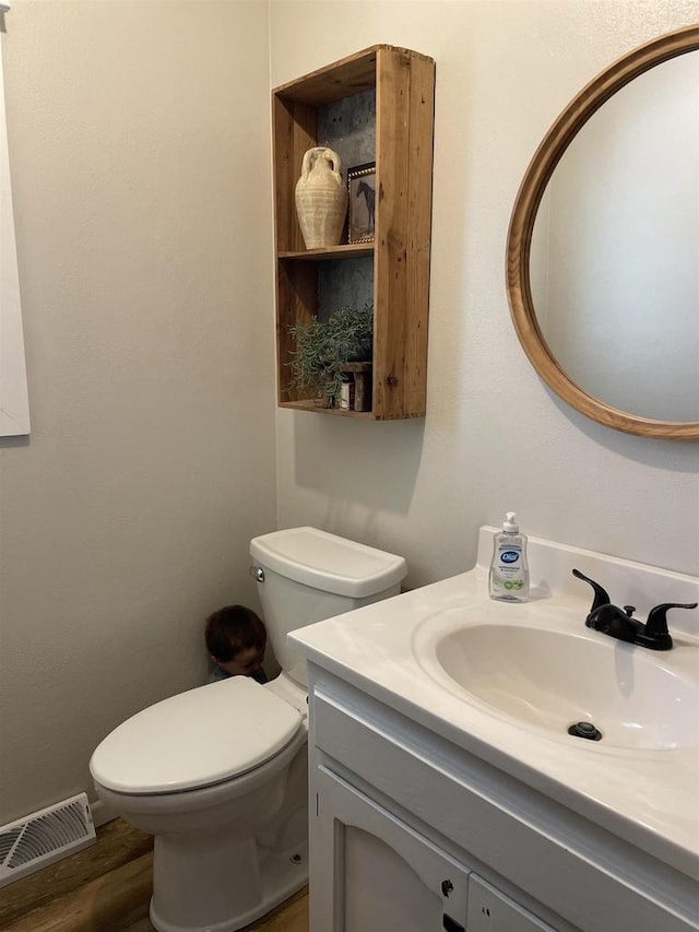 7401 Mildred Ct, Cross Plains, WI 53528 - bathroom with vanity, toilet, and wood finished floors